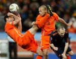 Spain’s Andres Iniesta, right, competes for the ball with Netherlands’ John Heitinga, center, and Netherlands’ Mark van Bommel, left, during the World Cup final soccer match between the Netherlands and Spain